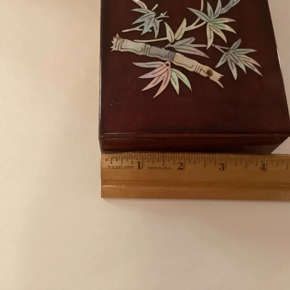 Vintage lacquered smoking box with mother of pearl inlay.
